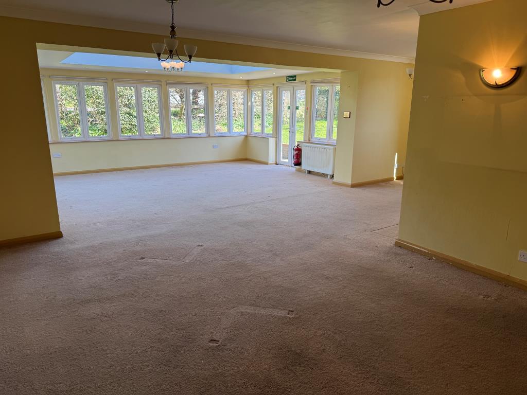 Lot: 86 - SUBSTANTIAL DETACHED PROPERTY WITH POTENTIAL PREVIOUSLY USED FOR SUPPORTED LIVING - Spacious living room with windows overlooking gardens
